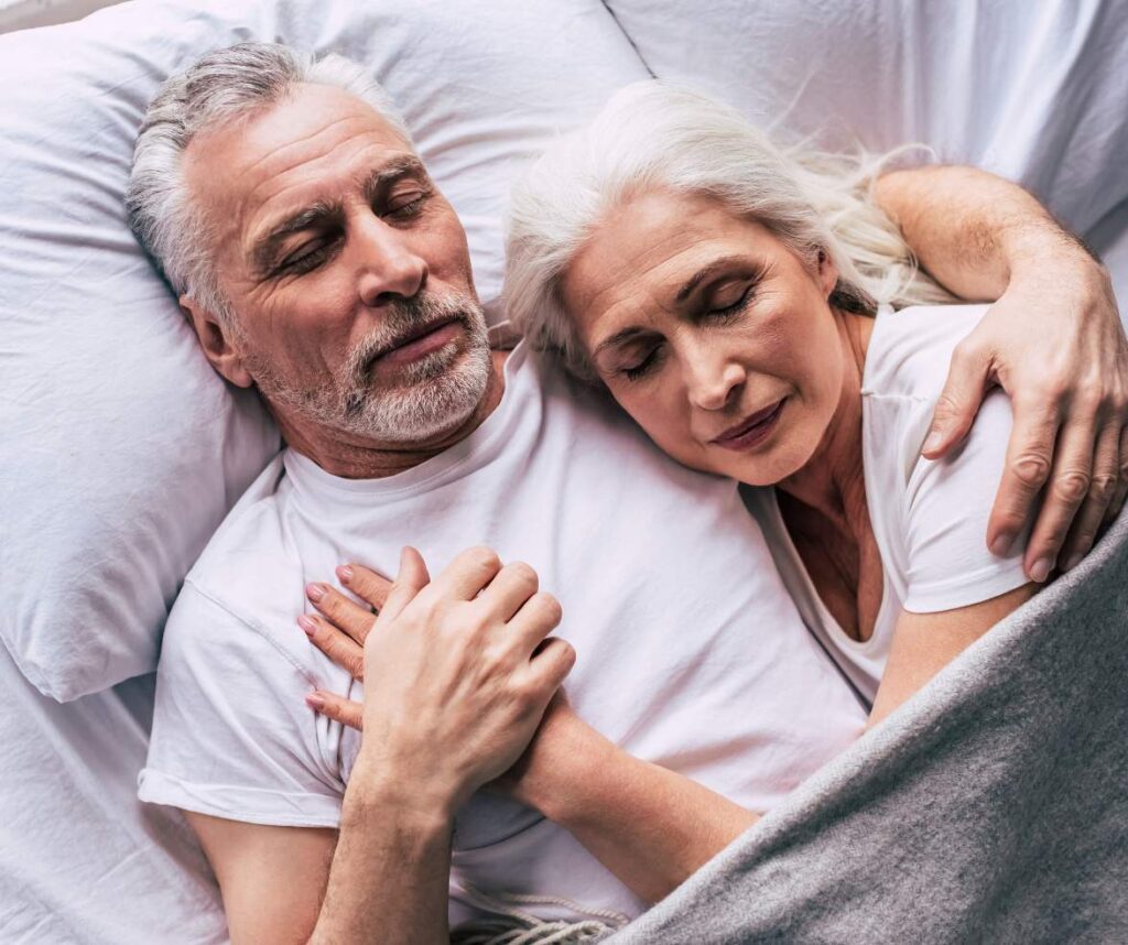 A man and woman peacefully sleeping after consuming CBD gummies for a restful night's sleep.