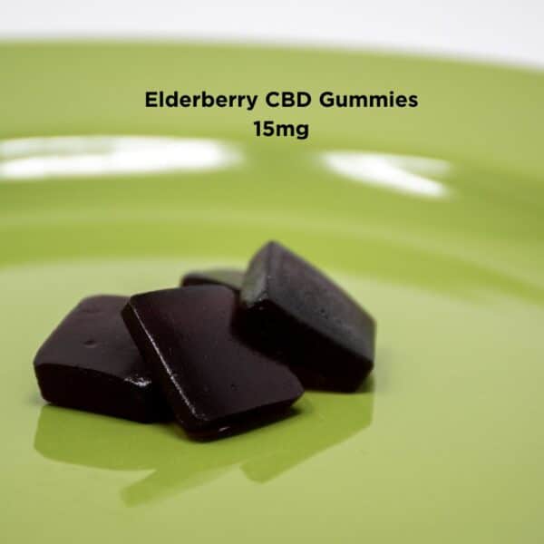 An image showing a vibrant green plate with four elderberry CBD gummies from Kentucky Cannabis Company. The gummies are dark purple, bear-shaped, and have a smooth, glossy finish, contrasting beautifully against the green background of the plate.